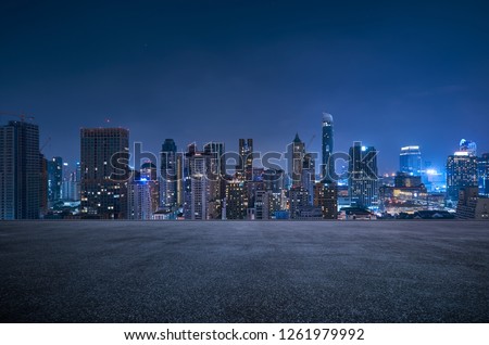 Photo of Bangkok urban cityscape skyline night scene with empty asphalt floor on front