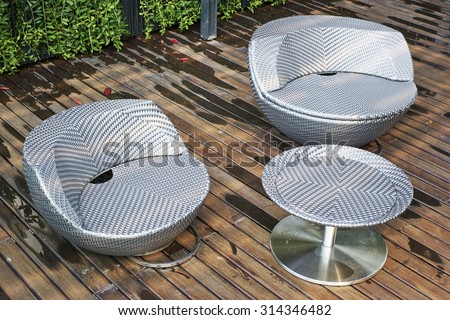 Two round grey fabric sofa and one grey round table on wooden floor