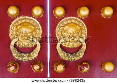 Chinese traditional designs(Qing dynasty style) red door with dragon head knob in Temple of Heaven,city Beijing, China. It reflects imperial power and the august presence.