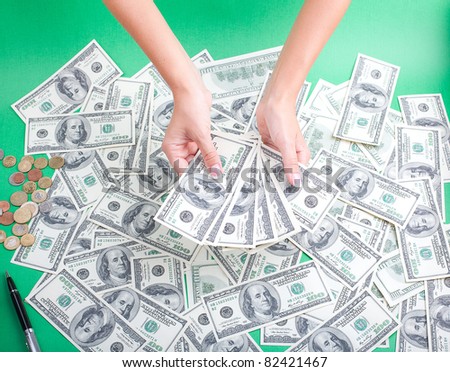 women\'s hands with a fan out of money
