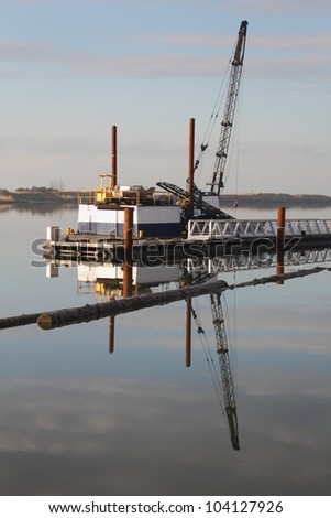 Construction Crane Barge, Steveston Harbor. Crane on a barge at dawn in Steveston Harbor. Richmond, British Columbia, Canada.