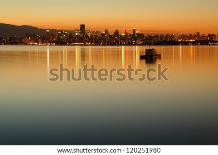 Vancouver Dawn Cityscape. A twilight morning view of downtown Vancouver across English Bay. British Columbia, Canada.