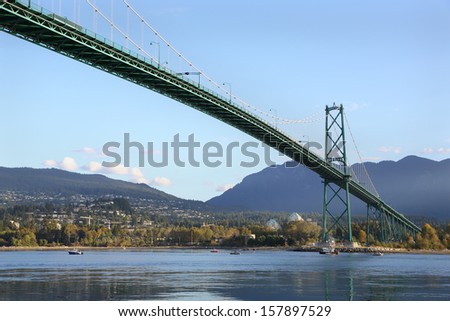 Sport Fishermen, Lions Gate Bridge, Vancouver. Sport fishermen troll for salmon from their boats under the Lions Gate Bridge at dawn. British Columbia, Canada.