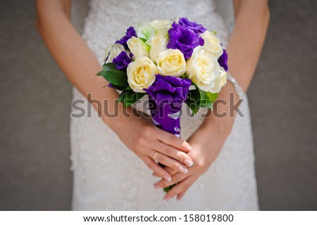 Beautiful wedding bouquet in hands of the bride
