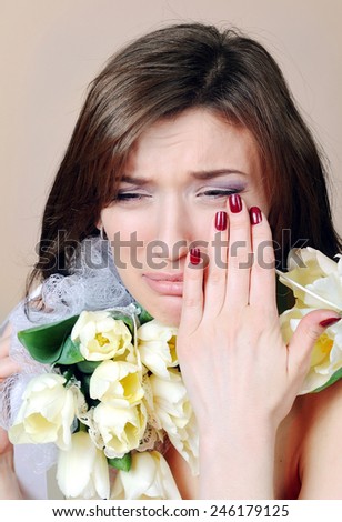 crying woman with white flowers tulips.