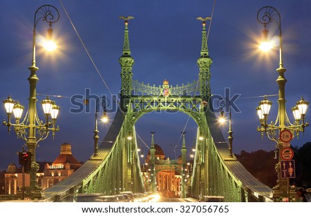 BUDAPEST / HUNGARY - SEPTEMBER 26: Liberty bridge at dusk, with unidentified people and buildings around on September 26, 2015 in Budapest, Hungary
