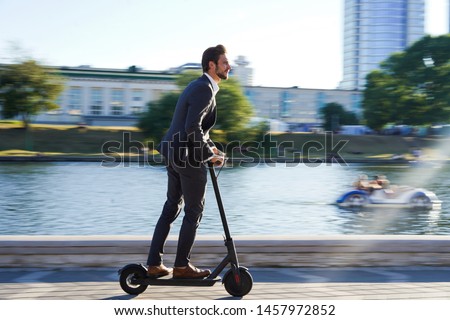 Similar – Image, Stock Photo Man riding an e-scooter