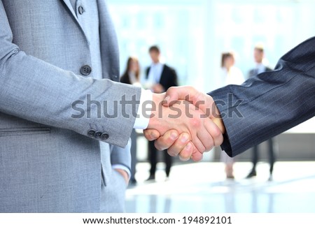 Closeup of a business handshake. Business people shaking hands, finishing up a meeting