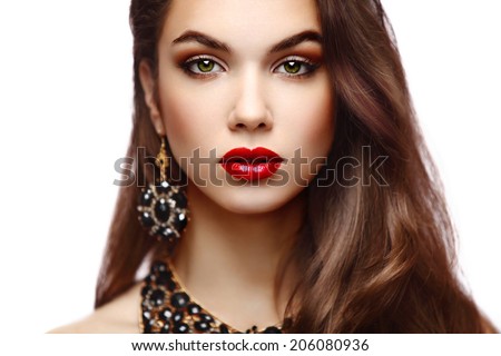 Beauty Model Woman with Long Brown Wavy Hair. Healthy Hair and Beautiful Professional Makeup. Red Lips and Smoky Eyes Make up. Gorgeous Glamour Lady Portrait.  Haircare, Skincare concept
