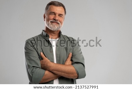 Similar – Image, Stock Photo Portrait of mature man with grey beard exploring Finland in winter. Traveler with camera on the top of rock. Beautiful view of northern landscape with frozen Baltic Sea and snowy islands.