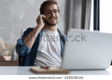 Similar – Image, Stock Photo Man talking on smartphone while browsing laptop