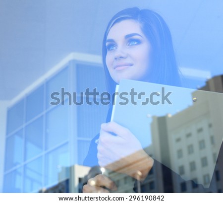 Face of beautiful woman on the background of business people - double exposure