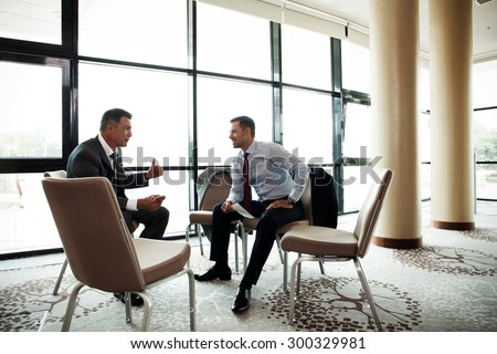 Coworkers discussing project in conference room