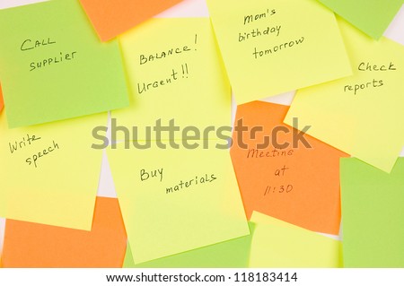 Close-up of many sticky notes with tasks illustrating daily rush