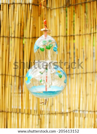 Wind-bell on barred lattice of bamboo background