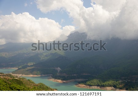 Mountain at water reservoir at hot noon
