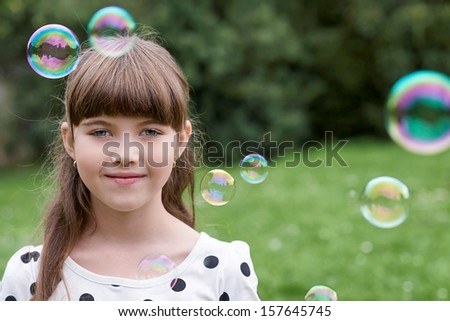 Young girl with a bubble by bubble blower