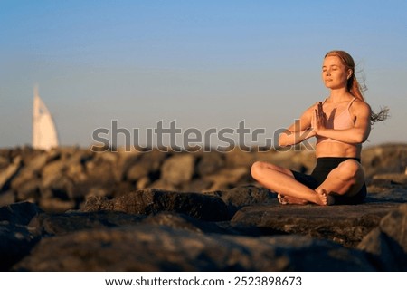 Similar – Image, Stock Photo Peaceful Arab woman doing yoga on embankment