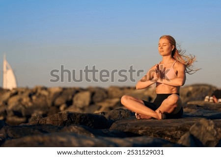 Similar – Image, Stock Photo Peaceful Arab woman doing yoga on embankment