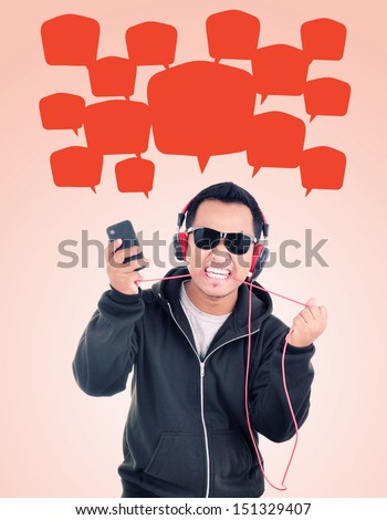 a man carrying Hand phones and biting headphones cable, isolated on white background
