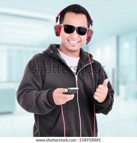 Portrait of a handsome young man listening to music indoor