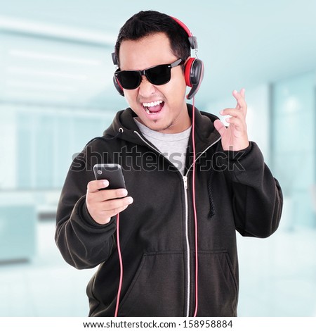 Portrait of a handsome young man listening to music indoor