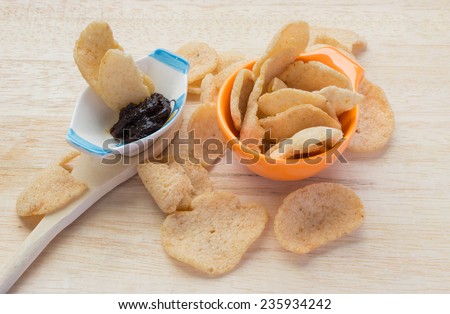 Thai crisp rice on the orange mini cup and thai spicy paste and mini cup on Wooden Spoon