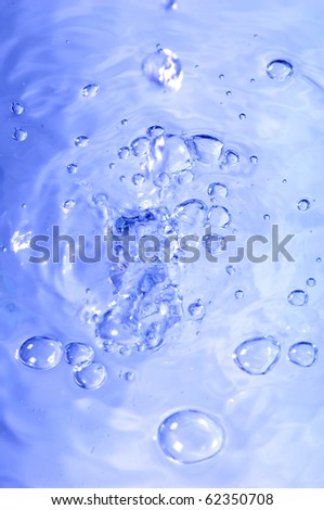 Blue water with air bubbles in the water line. Focus on the water line.