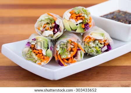 colourful chicken, sprouts and avocado rice paper spring rolls with soy base dip sauce