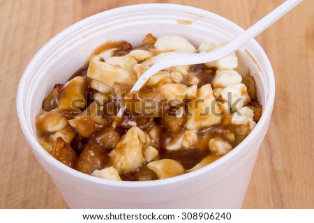 Poutine canadian fastfood meal with french fries, cheese curd and gravy