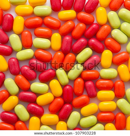 Colorful candy or medical pills as food or pharmacy background or texture. Easter card.