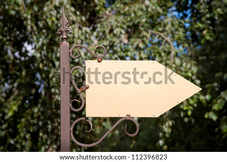 Wooden arrow cursor on a metal pole. Ready for your labels, logo or symbol.