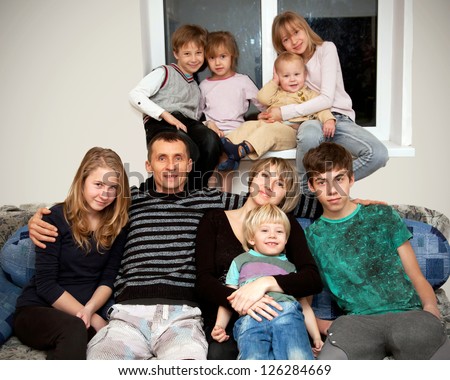 Happy big family. Father, mother and seven children at home. Family concept.