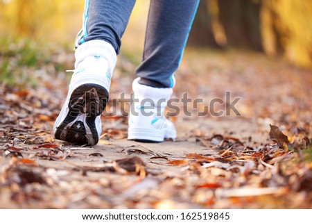 Runner running on the road. Close up running feet in trainers. Healthy lifestyle, fitness, jogging, active, young concept.