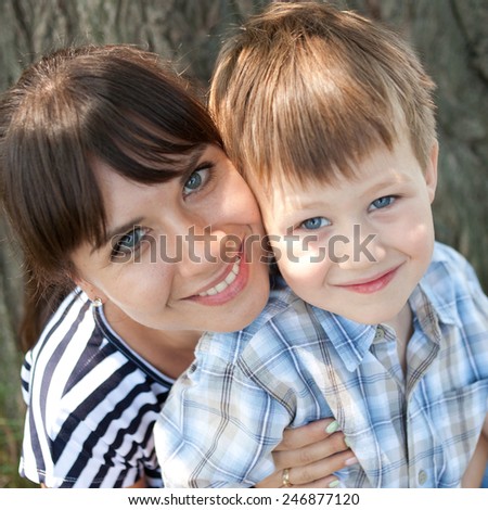 Mother and son are hugging and smiling