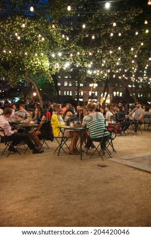 NEW YORK CITY - June 10: Customers dine at Shake Shack in Madison Square Park June 10, 2014 in New York, NY. The chain diner opened in 2004 and the Madison Square Park location is the original.