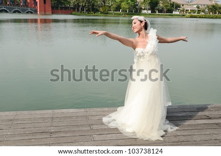 Beautiful girl in white gown of the bride dance