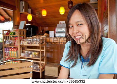 Smiling Asian girl in coffee shop