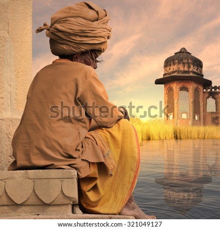 Old indian man near a traditional construction.