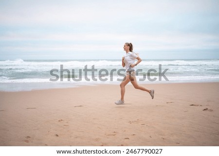 Image, Stock Photo Sportswoman on shore with paddle board