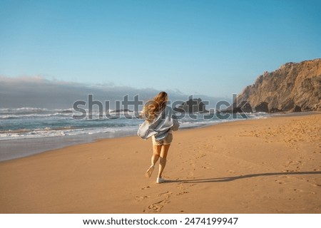 Similar – Image, Stock Photo Unrecognizable woman enjoying freedom near waving sea