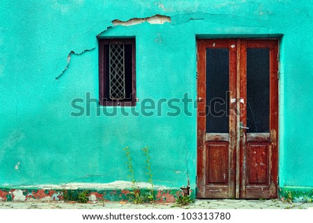 old house wall with wooden door and window