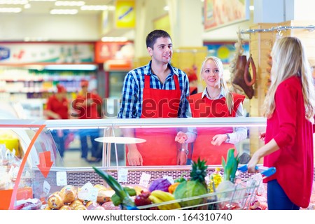 polite grocery staff serves customer in the mall