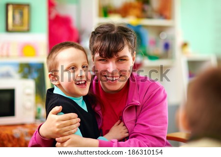 Similar – Image, Stock Photo Boy with special needs water color painting with both hands at the same time; AAC communication device sits nearby