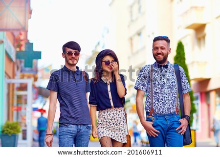candid portrait of friends walking the city street