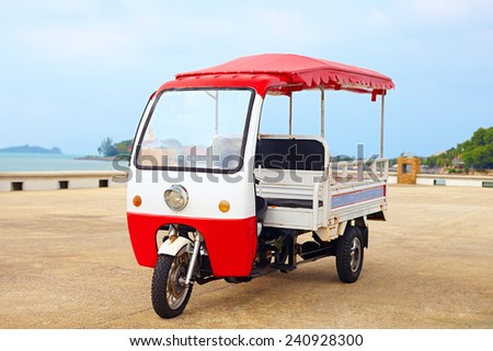 asian rickshaw vehicle parked on the road