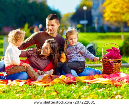 happy family on autumn picnic in park
