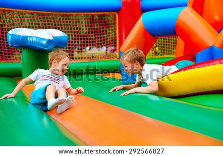 happy kids having fun on inflatable attraction playground