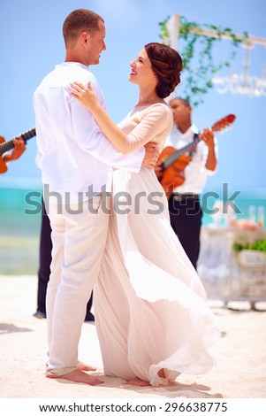 beautiful bride and groom dancing on tropical beach, caribbean wedding