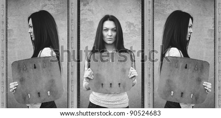 attractive serious brunette woman holding blank board in profile and full face. grunge, black and white